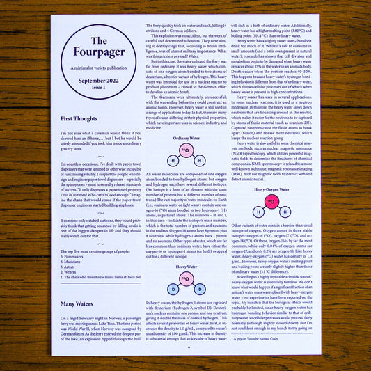Paper publication titled 'The Fourpager' on a wooden background. Below the title reads, 'A minimalist variety publication', 'September 2022', and 'Issue 1'.