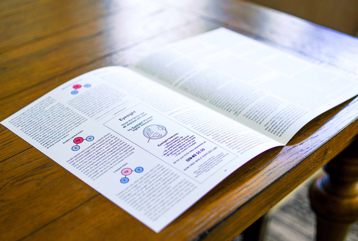 Paper publication, opened so the inner spread is visible, on a wooden table